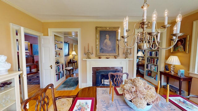 12 Center St, Machias, ME 04654 - living room with crown molding, a chandelier, a fireplace with flush hearth, and wood finished floors