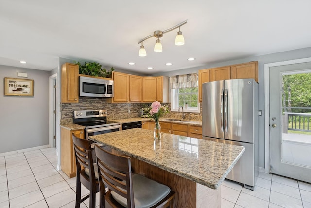 19 Straw Rd, Gorham, ME 04038 - kitchen with stainless steel appliances, light tile patterned floors, backsplash, a breakfast bar, and recessed lighting