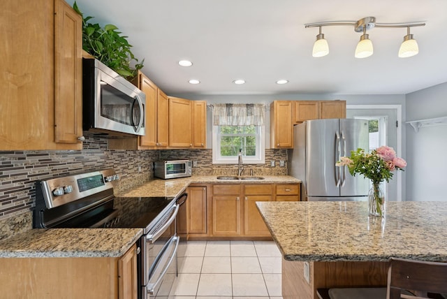 19 Straw Rd, Gorham, ME 04038 - kitchen featuring appliances with stainless steel finishes, tasteful backsplash, light tile patterned floors, light stone countertops, and recessed lighting