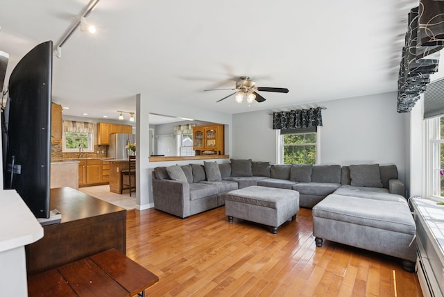19 Straw Rd, Gorham, ME 04038 - living room with track lighting, ceiling fan, healthy amount of natural light, and light wood-type flooring