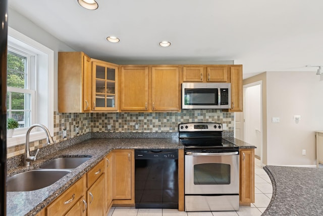 19 Straw Rd, Gorham, ME 04038 - kitchen featuring stainless steel appliances, tasteful backsplash, light tile patterned floors, glass insert cabinets, and dark stone countertops