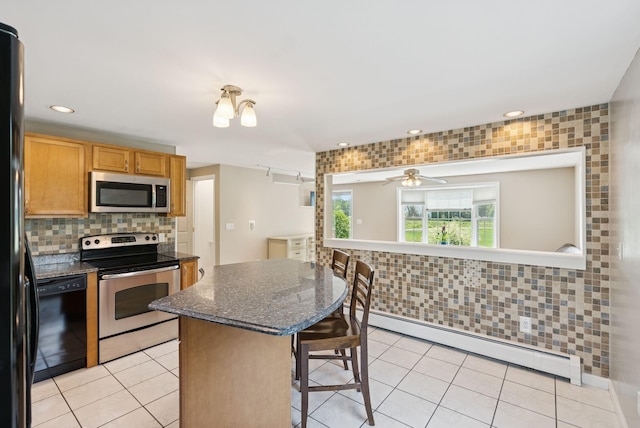 19 Straw Rd, Gorham, ME 04038 - kitchen featuring black appliances, a baseboard radiator, a breakfast bar, light tile patterned floors, and recessed lighting