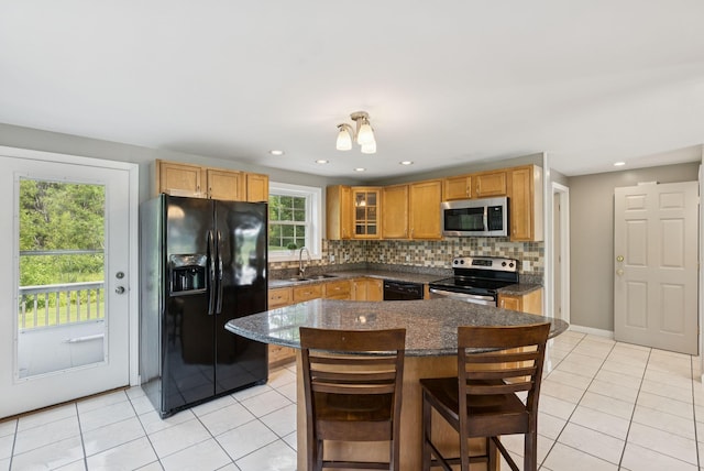 19 Straw Rd, Gorham, ME 04038 - kitchen featuring black appliances, light tile patterned floors, backsplash, glass insert cabinets, and a breakfast bar