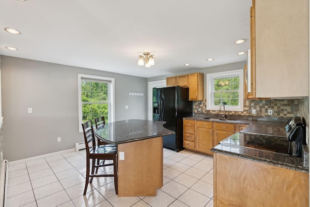 19 Straw Rd, Gorham, ME 04038 - kitchen featuring black refrigerator with ice dispenser, a center island, decorative backsplash, a kitchen breakfast bar, and recessed lighting
