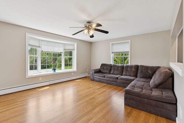 19 Straw Rd, Gorham, ME 04038 - living area with a baseboard heating unit, healthy amount of natural light, wood finished floors, and a ceiling fan