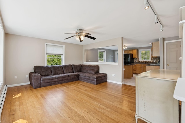 19 Straw Rd, Gorham, ME 04038 - living area with light wood-style floors, healthy amount of natural light, a ceiling fan, and rail lighting