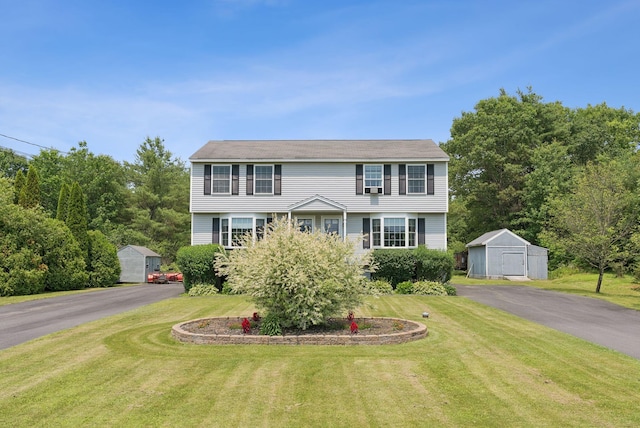 19 Straw Rd, Gorham, ME 04038 - colonial house featuring a storage unit, a front yard, and asphalt driveway