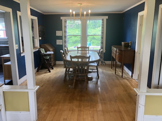16 N Main St, Morrill, ME 04952 - dining area with ornamental molding, wood-type flooring, and a chandelier