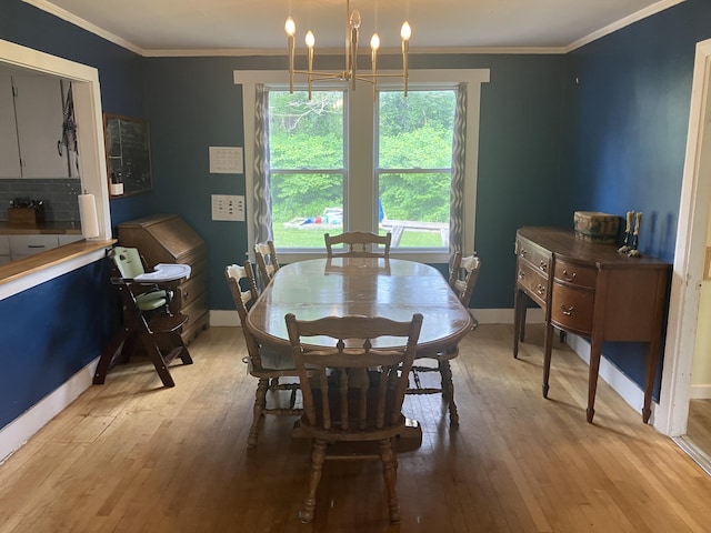 16 N Main St, Morrill, ME 04952 - dining room featuring light wood finished floors, a chandelier, and crown molding