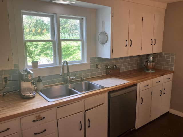 16 N Main St, Morrill, ME 04952 - kitchen featuring stainless steel dishwasher, butcher block countertops, decorative backsplash, and white cabinetry