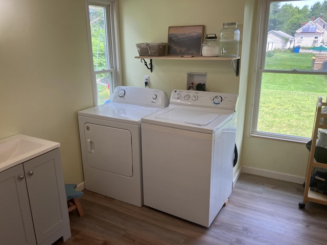16 N Main St, Morrill, ME 04952 - laundry room featuring separate washer and dryer, cabinet space, light wood finished floors, and plenty of natural light