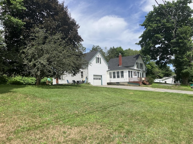 16 N Main St, Morrill, ME 04952 - view of front of property with an attached garage, a chimney, driveway, and a front yard