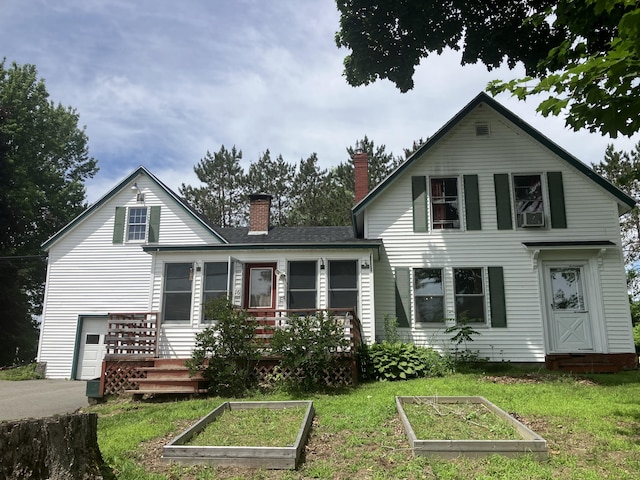 16 N Main St, Morrill, ME 04952 - view of front of house featuring a vegetable garden, a chimney, and a front lawn
