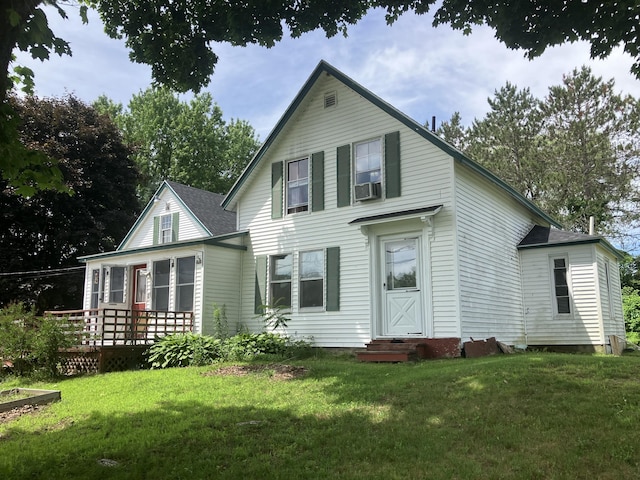 16 N Main St, Morrill, ME 04952 - view of front of home with a front yard, a deck, roof with shingles, and cooling unit