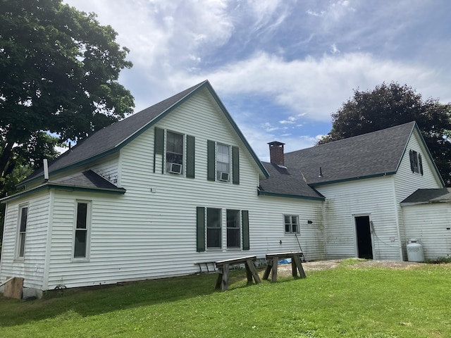 16 N Main St, Morrill, ME 04952 - rear view of property featuring a yard, a chimney, roof with shingles, and cooling unit