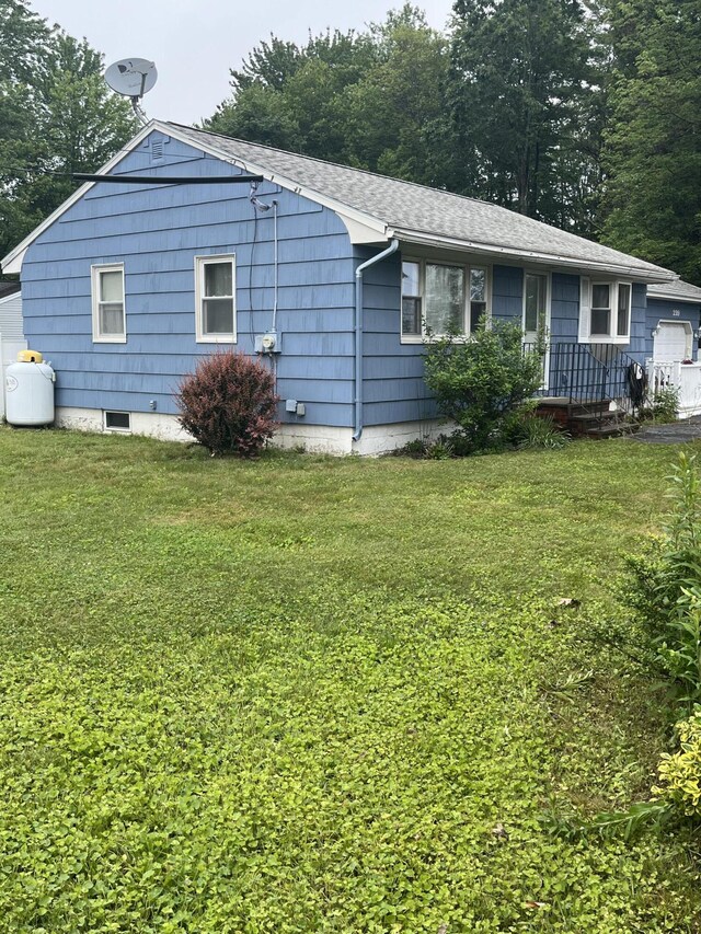 299 County Rd, Westbrook, ME 04092 - view of side of home featuring a yard, a shingled roof, and a garage