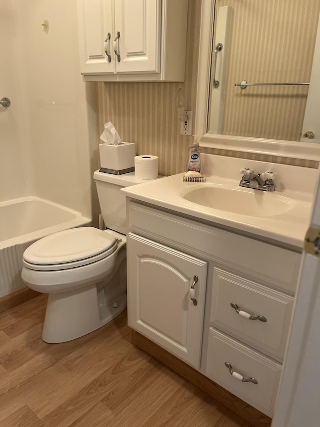 299 County Rd, Westbrook, ME 04092 - bathroom with wood finished floors, vanity, wallpapered walls, and shower / bathtub combination