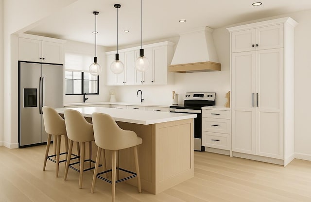 2 Moxie Ln, Biddeford, ME 04005 - kitchen with appliances with stainless steel finishes, premium range hood, light wood-style floors, a center island, and a kitchen bar