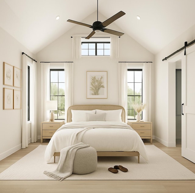 2 Moxie Ln, Biddeford, ME 04005 - bedroom with a barn door, high vaulted ceiling, light wood-style flooring, ceiling fan, and recessed lighting