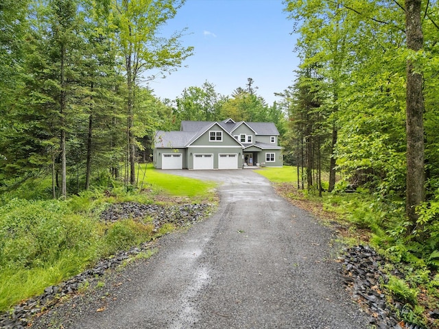 27 Meadow View Dr, Readfield, ME 04355 - view of front of home featuring a garage, driveway, and stucco siding