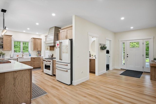 27 Meadow View Dr, Readfield, ME 04355 - kitchen featuring freestanding refrigerator, gas stove, custom range hood, light wood finished floors, and recessed lighting