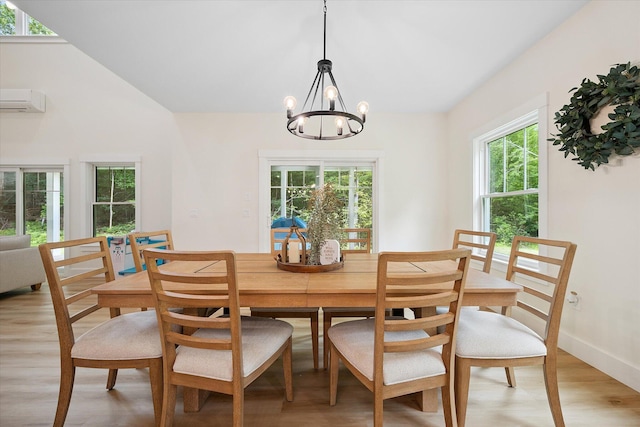 27 Meadow View Dr, Readfield, ME 04355 - dining space with a wall mounted air conditioner, light wood-type flooring, and a chandelier