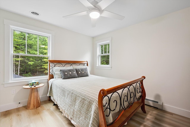 27 Meadow View Dr, Readfield, ME 04355 - bedroom featuring a baseboard radiator, wood finished floors, and a ceiling fan