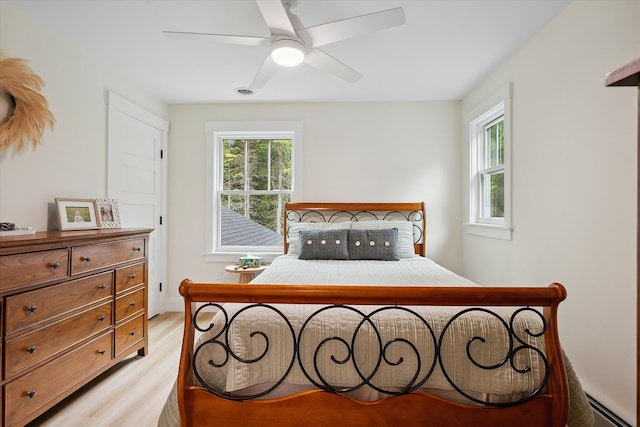 27 Meadow View Dr, Readfield, ME 04355 - bedroom with light wood-style floors, multiple windows, and a ceiling fan