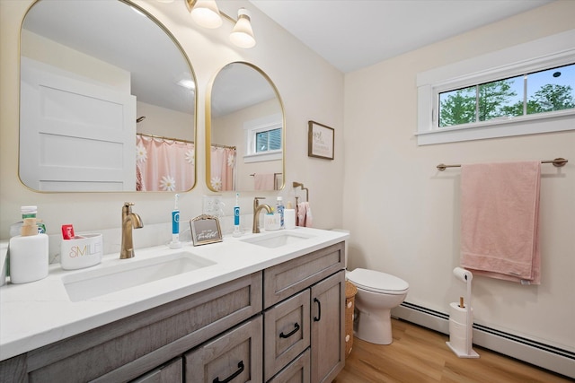 27 Meadow View Dr, Readfield, ME 04355 - full bathroom featuring double vanity, wood finished floors, healthy amount of natural light, and baseboard heating