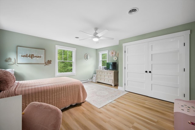 27 Meadow View Dr, Readfield, ME 04355 - bedroom with a baseboard radiator, wood finished floors, ceiling fan, and a closet