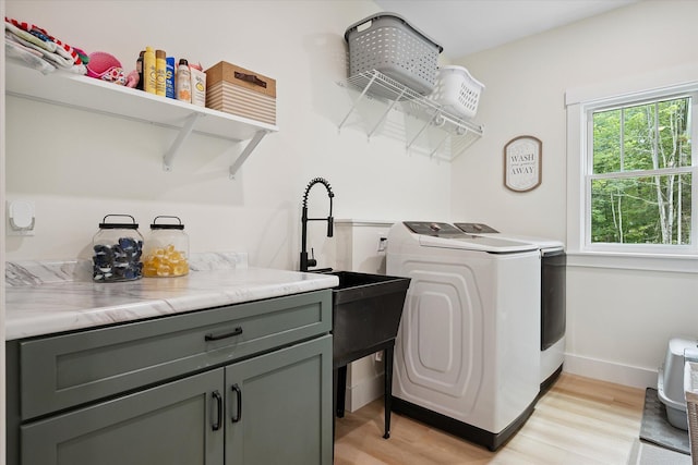27 Meadow View Dr, Readfield, ME 04355 - laundry area featuring separate washer and dryer, light wood-style flooring, and cabinet space