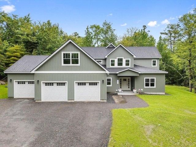 27 Meadow View Dr, Readfield, ME 04355 - view of front facade featuring roof with shingles, a front yard, a garage, and driveway