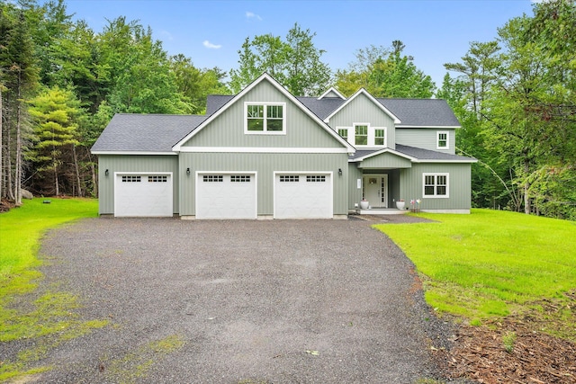 27 Meadow View Dr, Readfield, ME 04355 - view of front of house featuring a shingled roof, a front lawn, and a garage