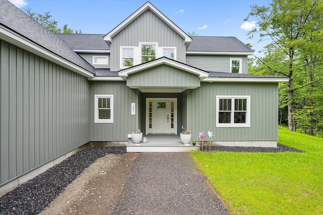 27 Meadow View Dr, Readfield, ME 04355 - property entrance with a lawn, a shingled roof, and board and batten siding
