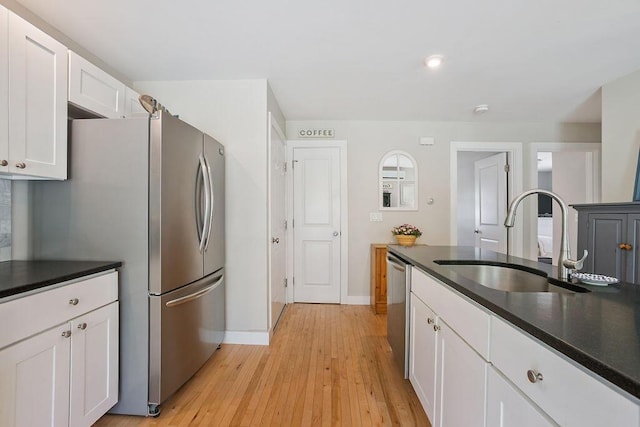 136-138 Blue Spruce Farm Rd, Westbrook, ME 04092 - kitchen featuring appliances with stainless steel finishes, dark countertops, white cabinets, light wood-style flooring, and recessed lighting