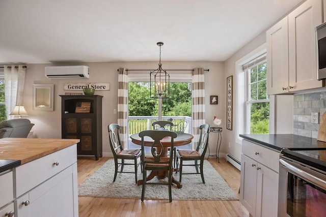 136-138 Blue Spruce Farm Rd, Westbrook, ME 04092 - dining area with a wall unit AC, a baseboard radiator, a chandelier, and light wood finished floors