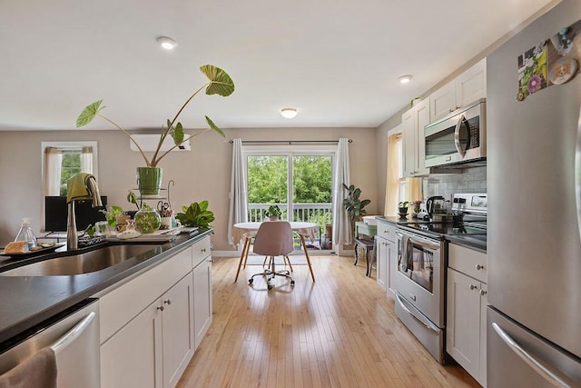 136-138 Blue Spruce Farm Rd, Westbrook, ME 04092 - kitchen with stainless steel appliances, healthy amount of natural light, dark countertops, white cabinetry, and recessed lighting