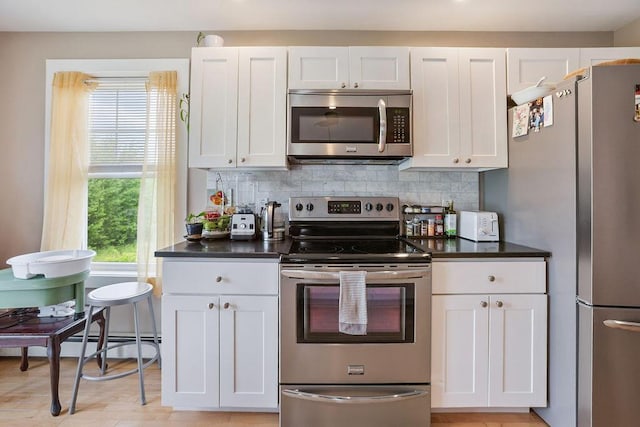 136-138 Blue Spruce Farm Rd, Westbrook, ME 04092 - kitchen featuring appliances with stainless steel finishes, white cabinets, and dark countertops