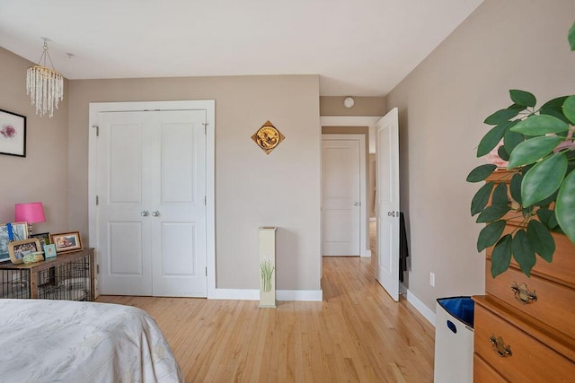 136-138 Blue Spruce Farm Rd, Westbrook, ME 04092 - bedroom with light wood finished floors, a closet, and a chandelier