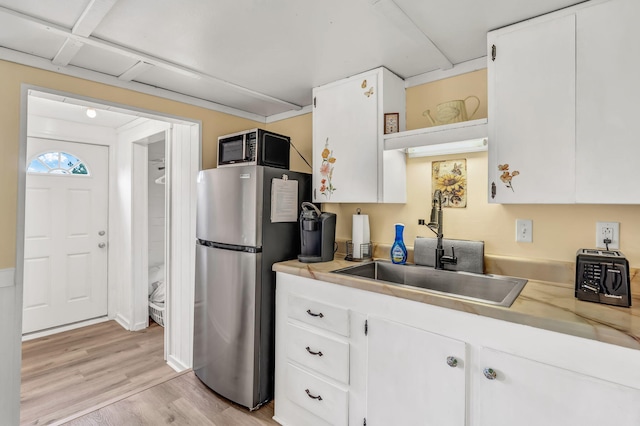 1511 Alna Rd, Alna, ME 04535 - kitchen featuring freestanding refrigerator, white cabinetry, light countertops, light wood finished floors, and open shelves