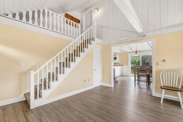 1511 Alna Rd, Alna, ME 04535 - staircase with a chandelier, wood finished floors, and high vaulted ceiling