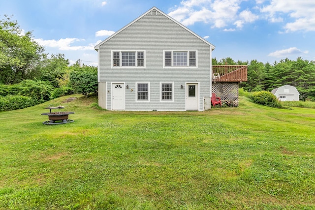 1511 Alna Rd, Alna, ME 04535 - rear view of house featuring a fire pit, a lawn, and a deck