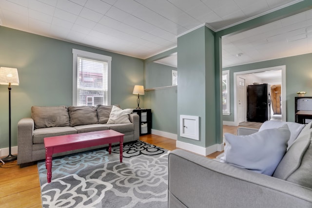 12 Maple St, Bath, ME 04530 - living area featuring plenty of natural light, wood finished floors, and ornamental molding