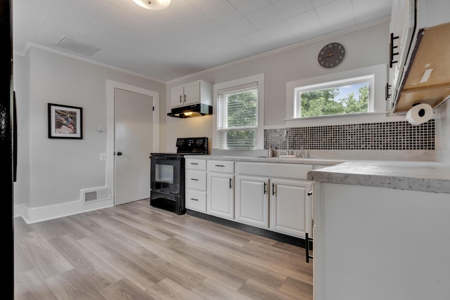 12 Maple St, Bath, ME 04530 - kitchen with electric range, ornamental molding, white cabinetry, light wood-style flooring, and decorative backsplash