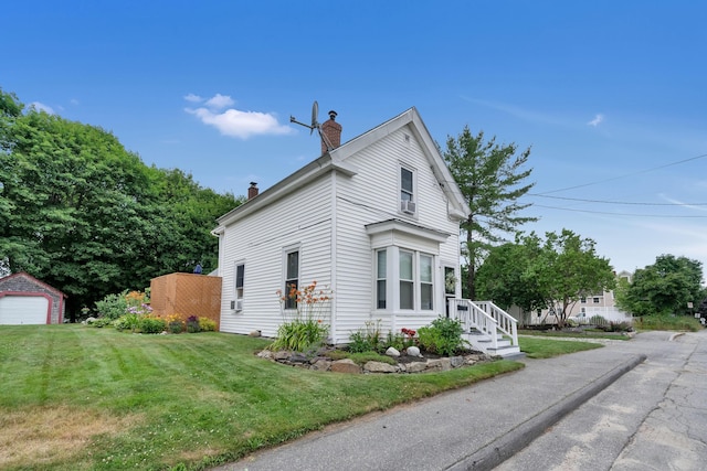 12 Maple St, Bath, ME 04530 - view of home's exterior with a chimney, a lawn, and an outbuilding