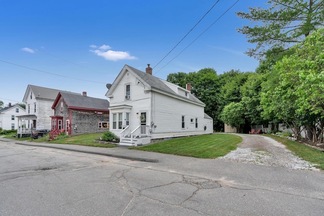 12 Maple St, Bath, ME 04530 - view of home's exterior with a chimney, a yard, and gravel driveway