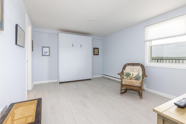 191 E Grand Ave Unit 506, Old Orchard Beach, ME 04064 - sitting room featuring light wood-style floors and a baseboard radiator
