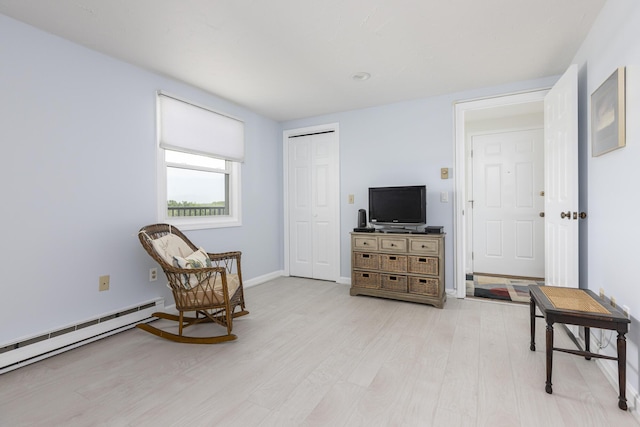 191 E Grand Ave Unit 506, Old Orchard Beach, ME 04064 - sitting room with baseboard heating and light wood-style flooring