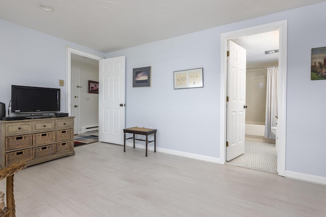 191 E Grand Ave Unit 506, Old Orchard Beach, ME 04064 - bedroom with a baseboard radiator and light wood-style flooring