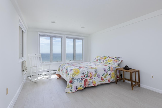 191 E Grand Ave Unit 506, Old Orchard Beach, ME 04064 - bedroom with a water view, wood finished floors, and a baseboard heating unit